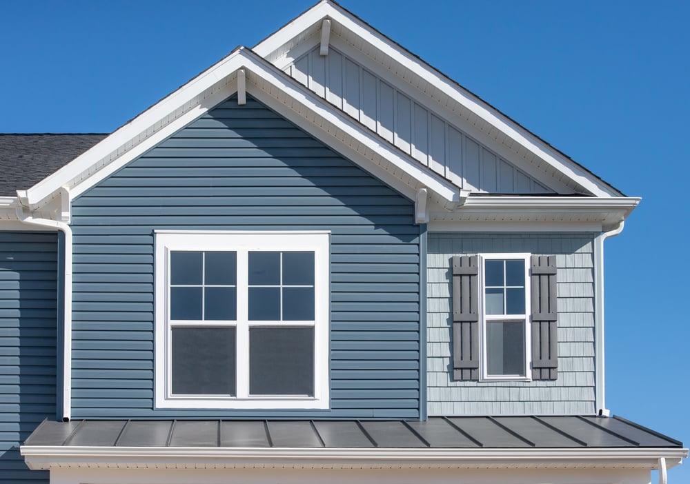 Vinyl windows on a blue house